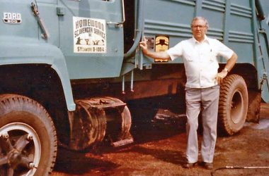 Wendell Yonker, the founder of Homewood Disposal, stands next to one of the trucks from the days when the company was known as Homewood Scavenger. (Provided photo/Homewood Disposal)