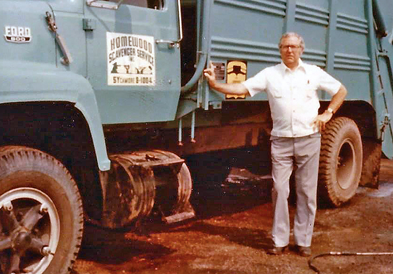Wendell Yonker, the founder of Homewood Disposal, stands next to one of the trucks from the days when the company was known as Homewood Scavenger. (Provided photo/Homewood Disposal)