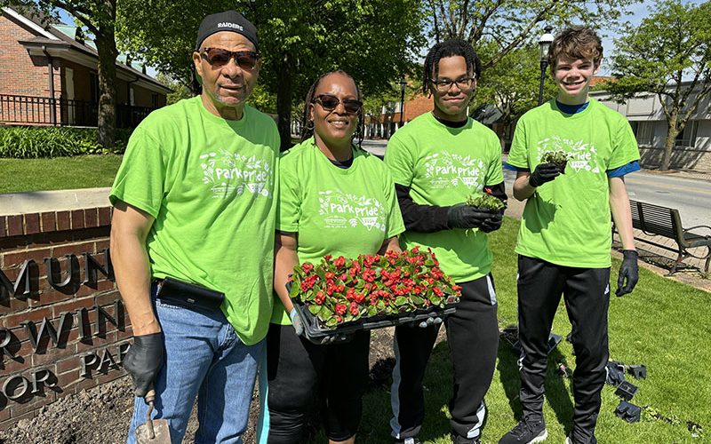 Ready to plant at the Irwin Park sign are, from left, Gregory and Catherine Dixon with Homewood-Flossmoor High students Isaiah Cole and Luke Debruin who are members of the H-F Key Club. (Marilyn Thomas/H-F Chronicle)