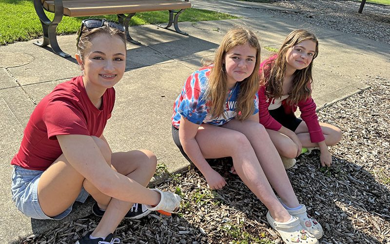 Working the weed patrol at Leavitt Park were, from left, Gina Bonanotte, Molly Tracy and Eleanor Greep, members of the Bel Canto Choir. (Marilyn Thomas/H-F Chronicle)