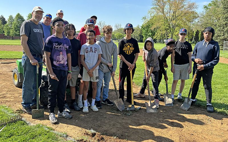 It was a team effort at Lions Park where players and coaches in the Babe Ruth 14U team worked on their home ball field. (Marilyn Thomas/H-F Chronicle)