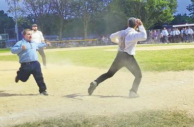 A Flossmoor Whistlestopper player prepares to throw as a Deep River player heads for third base during an old-timey baseball game Thursday, June 20, part of Flossmoor's centennial celebration. (Eric Crump/H-F Chronicle)