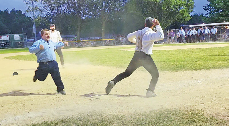 A Flossmoor Whistlestopper player prepares to throw as a Deep River player heads for third base during an old-timey baseball game Thursday, June 20, part of Flossmoor's centennial celebration. (Eric Crump/H-F Chronicle)
