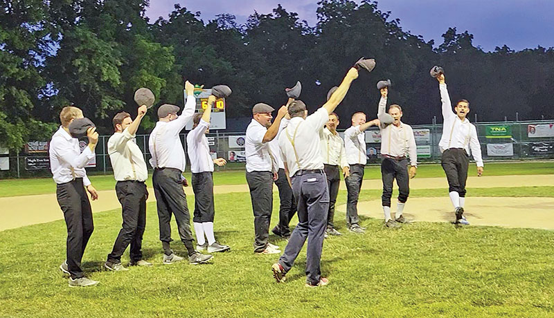 Flossmoor players doff their caps and give a shout to celebrate their victory in an exhibition baseball game that followed 1858 rules and traditions in celebration of the village's 100th birthday. (Eric Crump/H-F Chronicle)