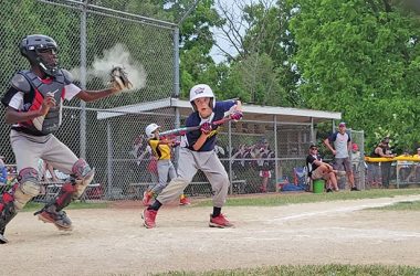 The batter shows bunt as the catcher prepares to throw to second in an attempt to thwart a steal during the youth baseball exhibition game at Flossmoor's centennial celebration on June 20. (Eric Crump/H-F Chronicle)