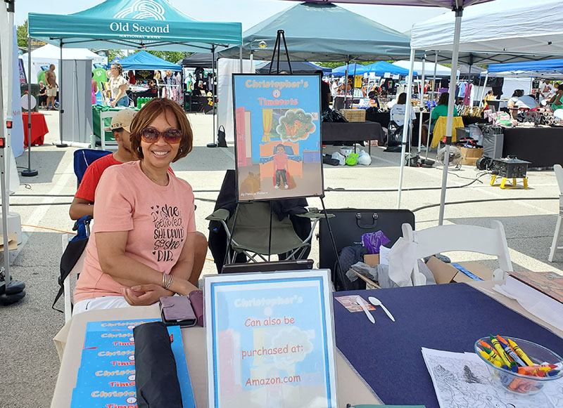 Author Patricia Wallace smiles next to her newest title. (Chris Weber/H-F Chronicle)
