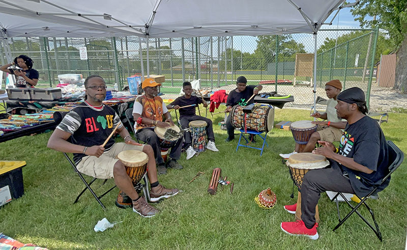 Eric-Olu Johnson of OSA Productions leads a drum circle during the HF Juneteenth Festival on June 15. (Nuha Abdessalam/H-F Chronicle)