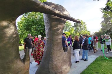 Flossmoor officials and residents of the Ballantrae neighborhood mingle in the shadow of "Paradise" by the late Hubert Phipps after a ribbon cutting ceremony on May 31 to mark the installation of the sculpture in Ballantrae Park, 1404 Lanark Ave. (Eric Crump/H-F Chronicle)