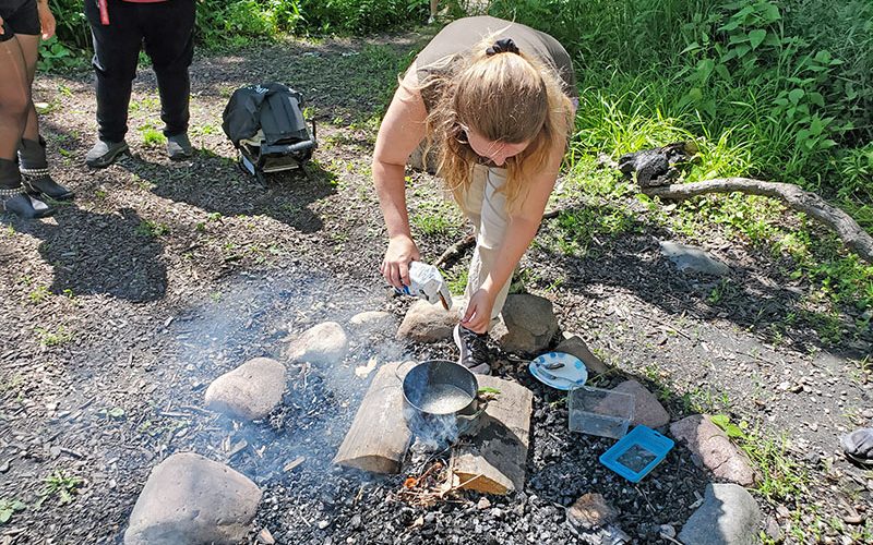 Dyana Metheny makes "candied cicadas" by sprinkling sugar on a boiled cicada. (Chris Weber/H-F Chronicle)