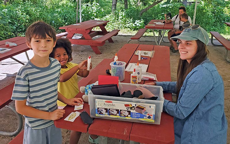 From left: Ari, Yara and Riley Gallagher make cicada models. (Chris Weber/H-F Chronicle)