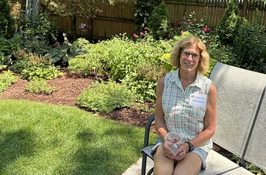 Beth Larocca takes a seat at the back of her garden. (Marilyn Thomas/H-F Chronicle)