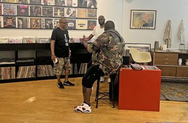 DJ 5ifth Element, far right, chatting with a customer and co-owner Tony Fields, left, at Conservatory Vintage and Vinyl. (Nick Ulanowski/H-F Chronicle)