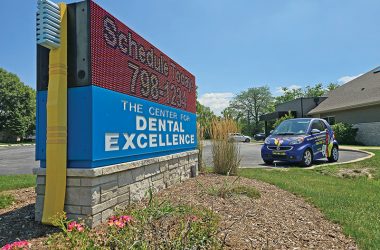 CDE smart car "Flossey" is parked near the practice's sign. (Eric Crump/H-F Chronicle)