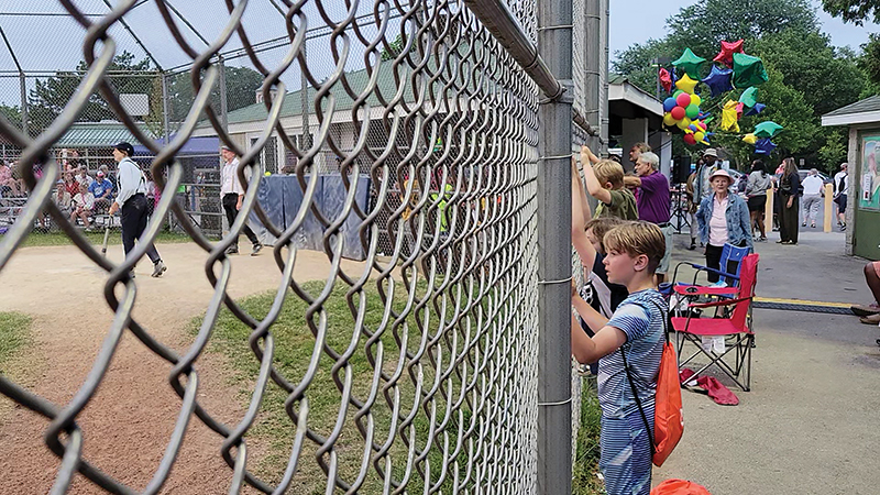Youngsters cling to the backstop of Bronco Field, engrossed in a vintage baseball game between the Flossmoor Whistlestoppers and the Deep River Grinders from Hobart, Indiana. The game was played by 1858 rules. (Eric Crump/H-F Chronicle)