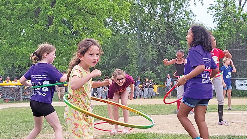 Kids do some hula hooping between ballgames at the Flossmoor centennial celebration. (Eric Crump/H-F Chronicle)