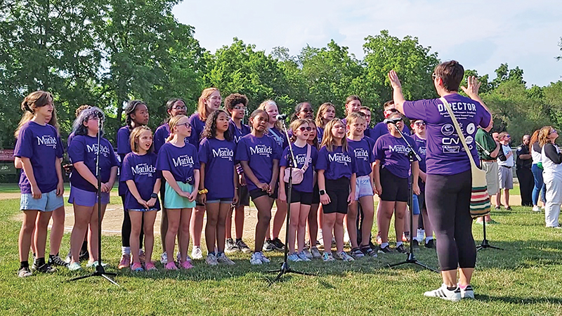 The cast of Spotlight Performance Academy's production of "Matilda Jr., the Musical" sing the national anthem directed by Carrie Bonanotte, Spotlight founder. (Eric Crump/H-F Chronicle)