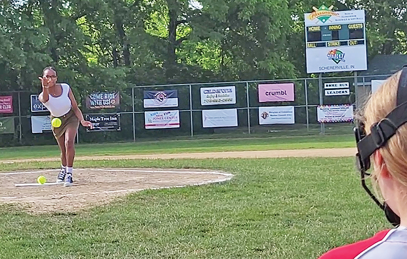 Parker Junior High Citizen of the Year Christiana Faith Brown delivers the first pitch prior to the Flossmoor centennial celebration exhibition softball game. (Eric Crump/H-F Chronicle)
