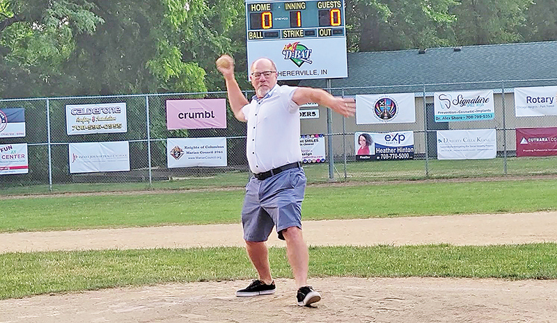 Former Flossmoor Baseball and Softball President Tom Dobrez throws the first pitch before the vintage baseball game. (Eric Crump/H-F Chronicle)