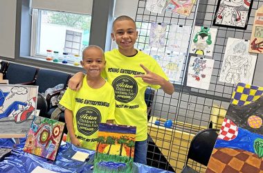 rothers Jaivyn, left, and Jason Frazier at their table featuring Jason's artwork. (Marilyn Thomas/H-F Chronicle)