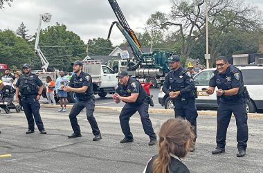 Flossmoor police officers play water balloon toss with kids during National Night Out. (Nuha Abdessalam/H-F Chronicle)