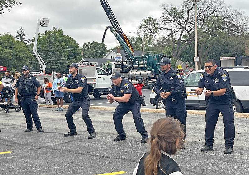 Flossmoor police officers play water balloon toss with kids during National Night Out. (Nuha Abdessalam/H-F Chronicle)