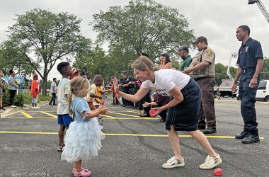 Mayor Michelle Nelson, right, high fives her partner in the balloon toss. (Nuha Abdessalam/H-F Chronicle)