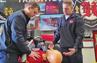Much has changed in the size and capabilities of the Homewood emergency medical service since it was founded five decades ago. Above, Firefighter/EMT Andrew Sline, left, and Capt. John Elashik demonstrate a new compression machine purchased early in 2023, one of the latest technology advances to improve EMS effectiveness in saving lives. (Eric Crump/H-F Chronicle)