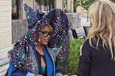 Sporting a witch's hat with flowing star-studded veil, Thandie Nee, left, talks with Homewood Business Association Executive Director Allisa Opyd during Witches' Night Out on Oct. 17. (Eric Crump/H-F Chronicle)