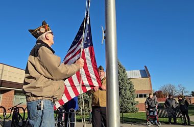 VFW Post 8077 members Don Tollefsen, left, and Jim Claydon prepare to raise the flag to kick of James Hart School's Veterans Day event on Nov. 11. (Eric Crump/H-F Chronicle)