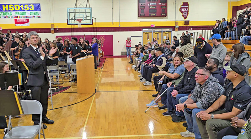 James Hart students and staff applaud as local veterans take their seats before the start of the Veterans Day program on Nov. 11. (Eric Crump/H-F Chronicle)