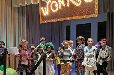 Children in the "Wonka" cast prepare to take a bow at the end of the show on Nov. 22. (Marilyn Thomas/H-F Chronicle)