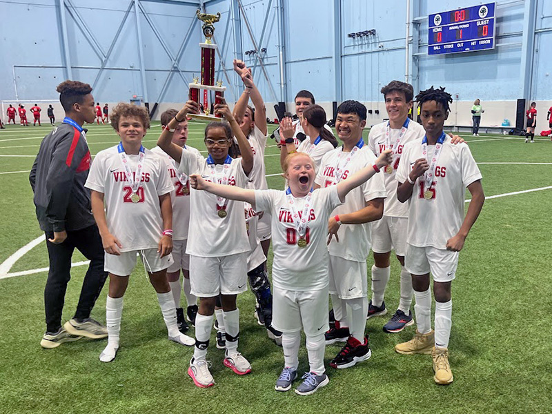 Members of the H-F white team hold their first place trophy aloft after taking two games in the state's Special Olympics soccer tournament. (Provided photo)