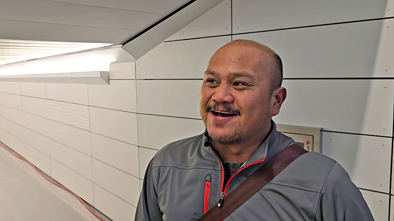 Mark Cudiamat of Homewood offers an initial impression of the new east side entrance to Homewood station. (Eric Crump/H-F Chronicle)