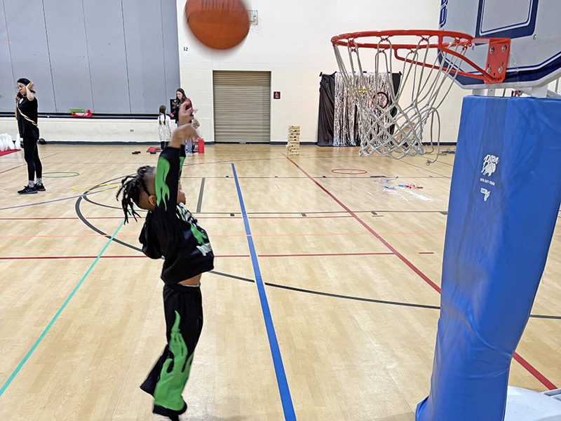 Masai McEwen, 5, had great aim hitting the basket during play time before the Noon Year's Eve celebration at the H-F Park District Sports Complex on Dec. 31. (Marilyn Thomas/H-F Chronicle)
