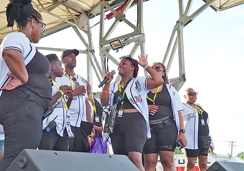 You Matter 2 CEO Destiny Watson, with mic, thanks the team that managed the 2024 Juneteenth Festival for their hard work. (Eric Crump/H-F Chronicle)