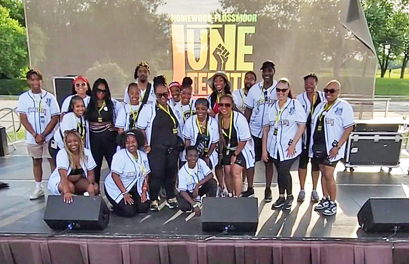 You Matter 2 CEO Destiny Watson is surrounded by members of the organization and volunteers who planned and operated the 2024 Juneteenth Festival at Homewood-Flossmoor High School. (Eric Crump/H-F Chronicle)