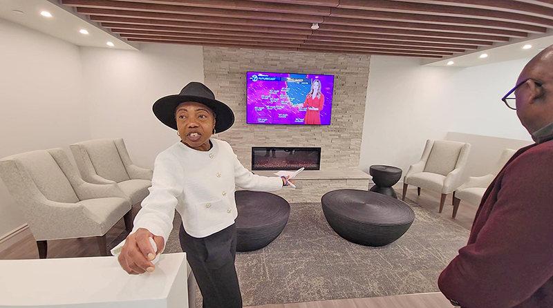 A guide shows grand opening guests a lounge area in House of Goshen, a new hospice in Flossmoor. (Eric Crump/H-F Chronicle)