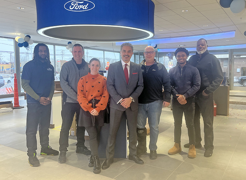 Fort of Homewood team members, from left, Bradley Reed, Jeff Moyers, Sarah Lovitt, owner Steve Phillipos, Bob Cuban, Samuel Bailey and Daniel Wood, inside the remodeled show floor. (Nick Ulanowski/H-F Chronicle)