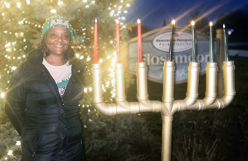 Cheryl Shackelford of Flossmoor poses after lighting the Kiara on day five of Kwanzaa. (Faith Lee/H-F Chronicle)