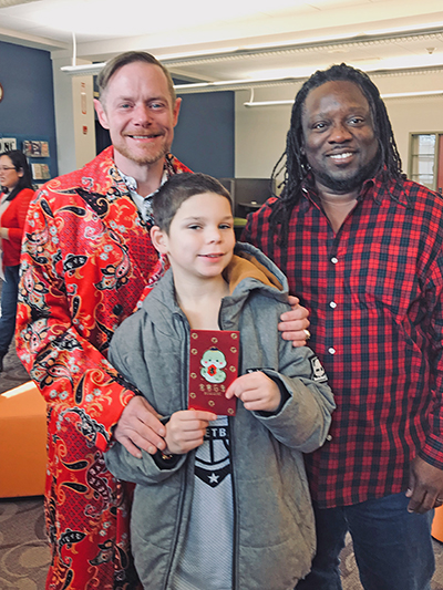 From left, Troy, Nigel and Qadree Holmes at the Lunar New Year celebration at Flossmoor Public Library. (Lolita Cusic/H-F Chronicle)