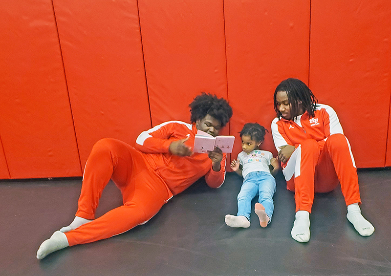 Idris Akeeb shares a story with Iris and Xavier Mohead during the MLK Day of Service Readers are Leaders event on Jan. 20. (Chris Weber/H-F Chronicle)