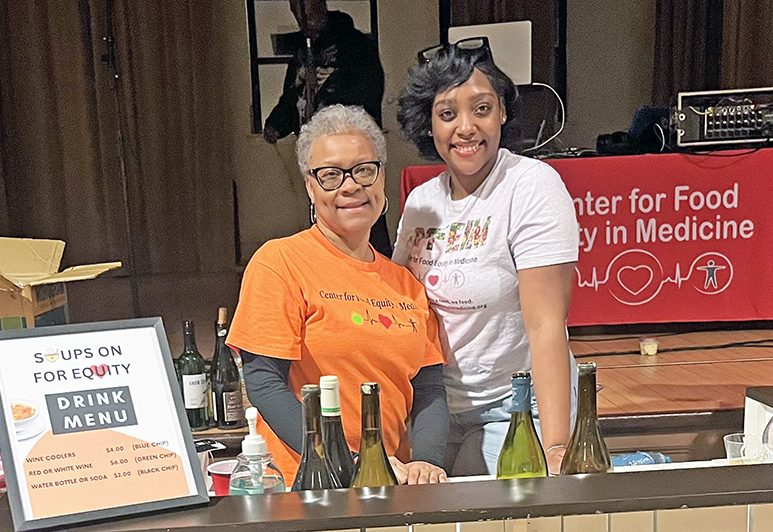 Center for Food Equity in Medicine volunteers Kim Thompson, left, and Nadja Sowell serve wine from Dunning’s Market. (Nick Ulanowski/H-F Chronicle)