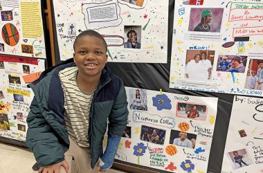 Reign Odom, a fourth grader, gets down to proudly show off his project on basketball star Napheesa Collier of the Women's National Basketball Association. (Marilyn Thomas/H-F Chronicle)