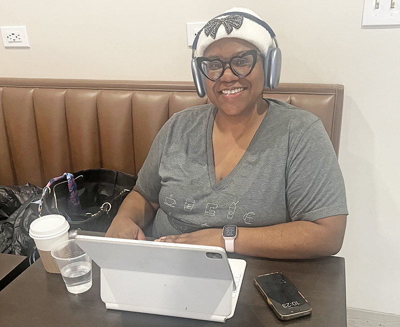 Flossmoor resident Charlotte Smith enjoys a vanilla oat milk latte and working on her laptop during Primo's Grand Opening celebration. (Nick Ulanowski/H-F Chronicle)