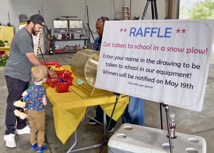 A youngster picks out his prize for finding an orange rock at the prize/raffle table during the Homewood Public Works Open House on May 17. (Summer Kiswani/H-F Chronicle)