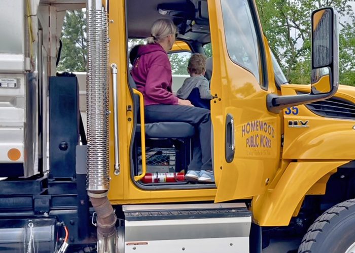 A family explores the inside of a Homewood Public Works truck. (Summer Kiswani/H-F Chronicle)