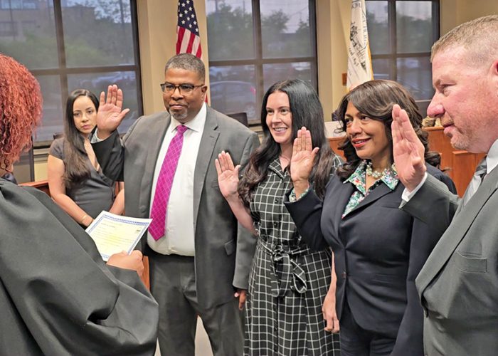 From left, Judge Barbara Dawkins administers the oath of office to trustees Phil Mason, Lauren Roman, Vivian Harris-Jones and Patrick Siemsen at the May 13 Homewood board meeting. (Eric Crump/H-F Chronicle)