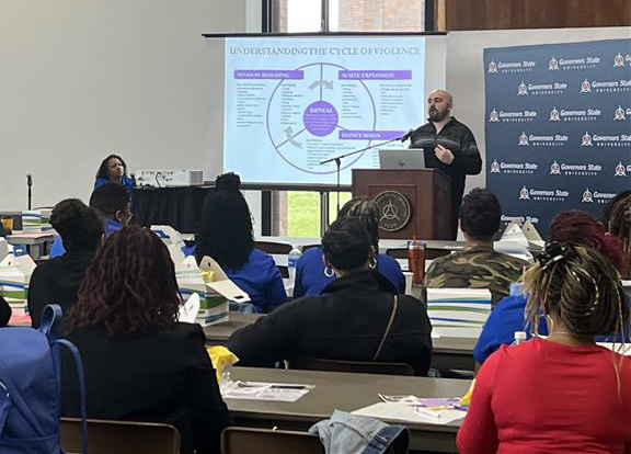 Anew Community Education Advocate Bo Hauptly gives a presentation at Governor's State University. (Provided photo)