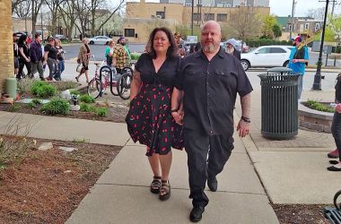 Raiye Rosado, left, and Tobias Cichon, owners of Rabid Brewing, lead a contingent of patrons into the April 22 village board meeting. (Eric Crump/H-F Chronicle)