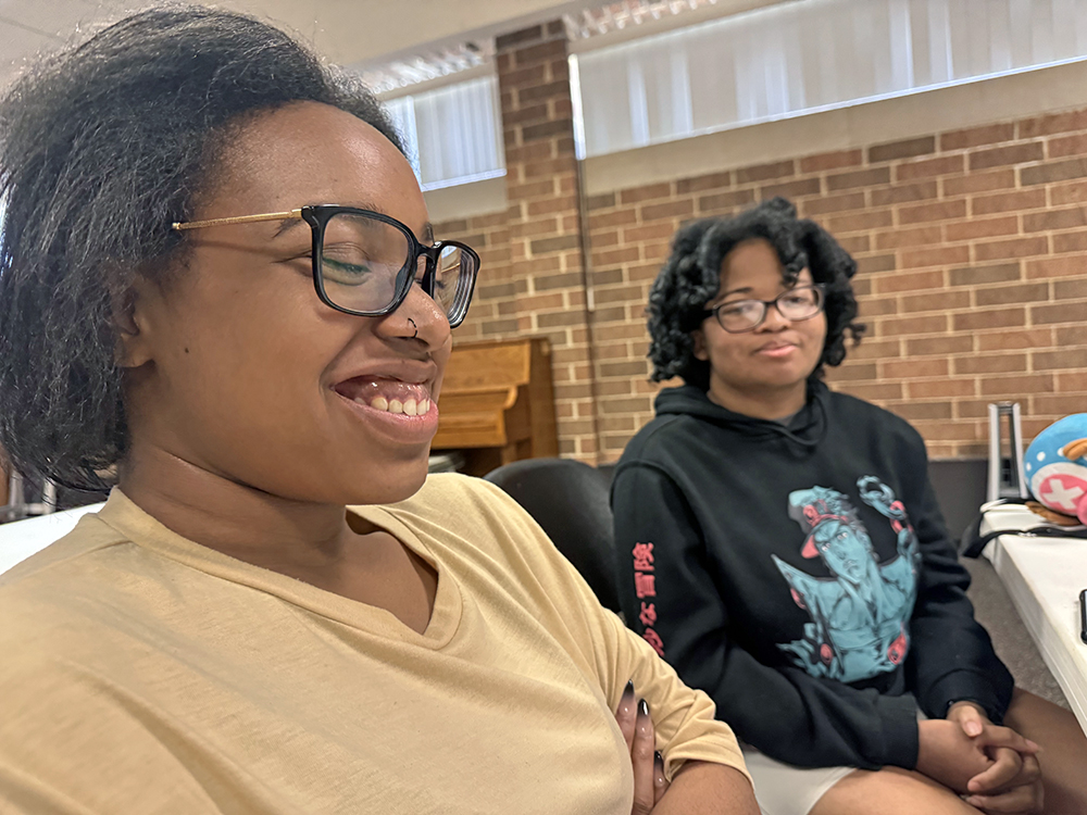 Homewood Flossmoor High School seniors Sylbrea Booth, left, and Ava Taylor are engrossed in Jennifer Murtoff’s presentation about chicken-keeping. Both students said they are interested in farm-related activities like taking care of chickens. (Karen Torme Olson/H-F Chronicle)